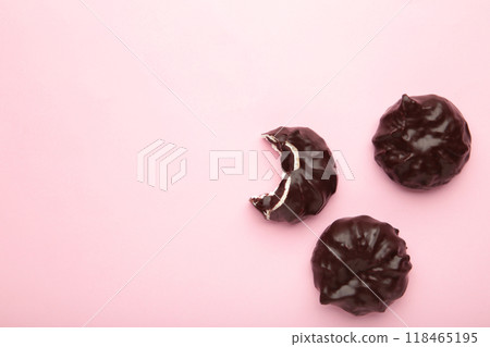 Chocolate covered marshmallows on pink background. Minimalism Chocolate covered marshmallows on pink background. Minimalism 118465195
