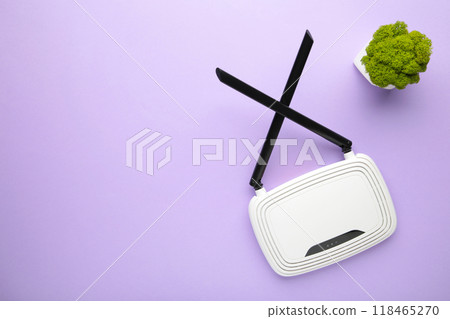 Wireless Wi-Fi router on purple background with copy space Wireless Wi-Fi router on purple background with copy space 118465270