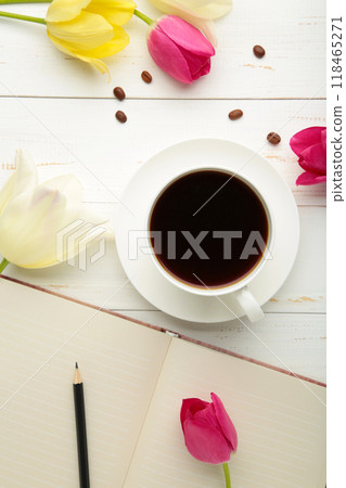 Notebook with cup of coffee and tulips on light background Notebook with cup of coffee and tulips on light background 118465271