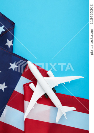 Toy plane with american flag on blue background. Vertical photo. Travel Toy plane with american flag on blue background. Vertical photo. Travel 118465308