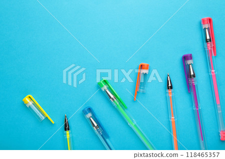 Different colors pens on blue background. Top view 118465357