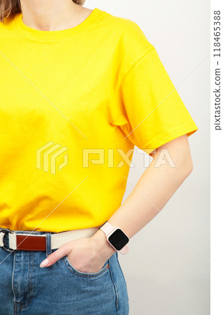 Young girl in yellow T-shirt on a grey background. T-shirt design and people concept - close up. 118465388