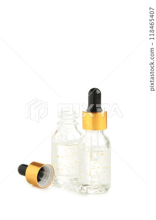 A glass bottles with a pipette with oil, serum isolated on white background with copy space. Flatlay A glass bottles with a pipette with oil, serum isolated on white background with copy space. Flatlay 118465407