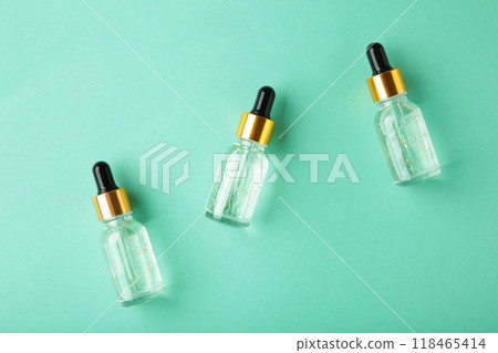 A glass bottles with a pipette with oil, serum on grey background with copy space. Flatlay A glass bottles with a pipette with oil, serum on grey background with copy space. Flatlay 118465414
