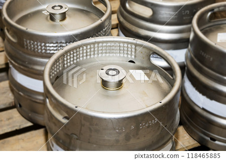 A meticulously stacked collection of beer kegs prepared and ready for distribution delivery A meticulously stacked collection of beer kegs prepared and ready for distribution delivery 118465885