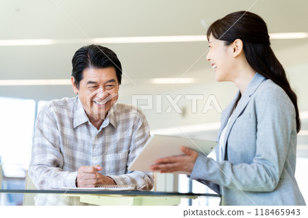 Senior man consulting with a friend. Photo courtesy of Denpa Gakuen, Tokyo Electronics College. 118465943
