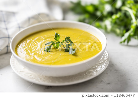 Healthy creamy vegetable soup in a white bowl. 118466477