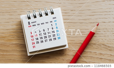 August 2025 calendar and red pencil on wooden desk August event calendar 118466503