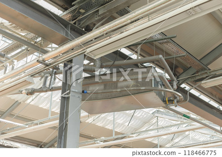 Industrial air conditioning handling unit suspended on frame construction under ceiling 118466775