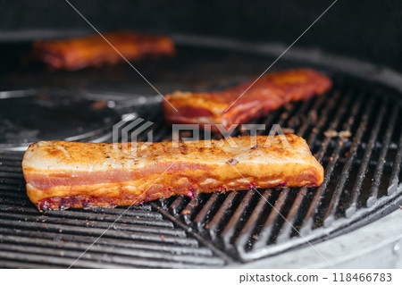Mouthwatering Rack of Ribs on Round Grill. Glazed Barbecue Meat Over Hot Coals 118466783