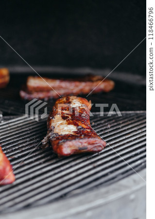 Mouthwatering Rack of Ribs on Round Grill. Glazed Barbecue Meat Over Hot Coals 118466796