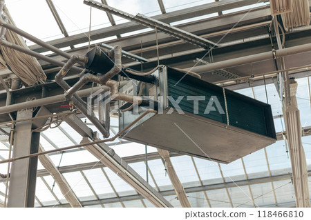 Industrial air conditioning handling unit suspended on frame construction under ceiling 118466810
