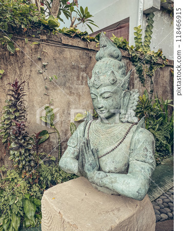 A traditional Hindu god statue decorates the courtyard 118466915