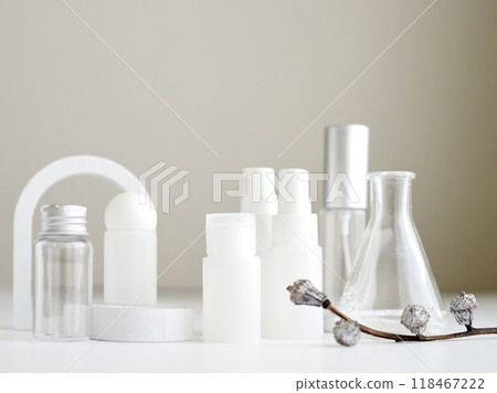 White cosmetic bottles and plants with botanical images 118467222