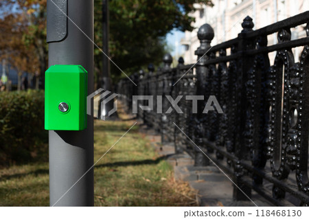 Button for changing the traffic light mode at pedestrian crossing. Button for pedestrians on pole to change traffic light signal to cross the road 118468130
