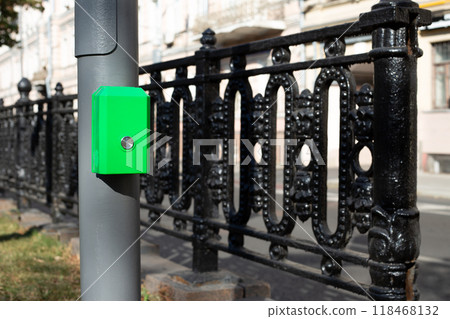 Button for changing the traffic light signal for pedestrians near the road to cross the street, modern convenient technologies for city life 118468132