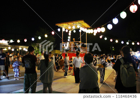 Dancing to the rhythm of the drums. A traditional Japanese summer night. Enjoy the Bon Odori dance. Dancing to the rhythm of the drums. A traditional Japanese summer night. Enjoy the Bon Odori dance. 118468436
