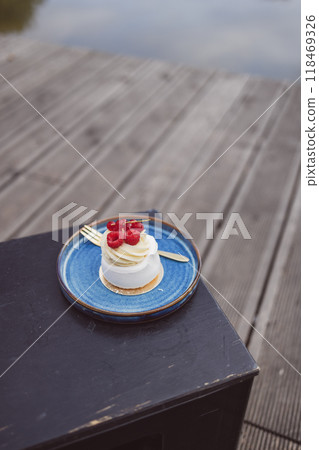 Beautiful tasty white cake with white cream and fresh raspberries at cafe. Sweet summer dieting dessert. High quality FullHD footage Beautiful tasty white cake with white cream and fresh raspberries at cafe. Sweet summer dieting dessert. High quality FullHD footage 118469326