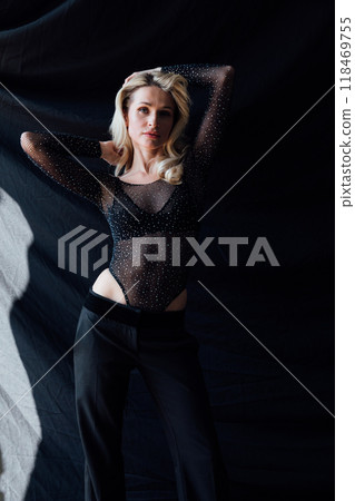 Portrait of a beautiful blonde woman in a black business pantsuit Portrait of a beautiful blonde woman in a black business pantsuit 118469755