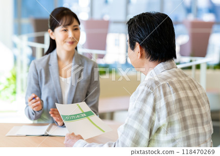A businesswoman selling to a senior man. Photo courtesy of Denpa Gakuen, Tokyo Electronics College. A businesswoman selling to a senior man. Photo courtesy of Denpa Gakuen, Tokyo Electronics College. 118470269