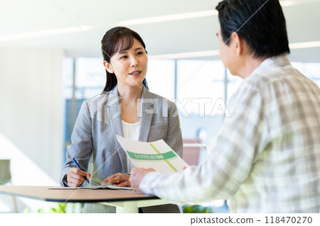 A businesswoman selling to a senior man. Photo courtesy of Denpa Gakuen, Tokyo Electronics College. A businesswoman selling to a senior man. Photo courtesy of Denpa Gakuen, Tokyo Electronics College. 118470270