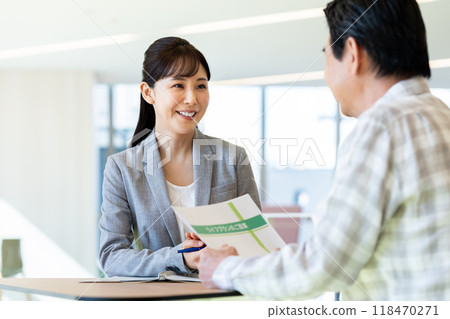 A businesswoman selling to a senior man. Photo courtesy of Denpa Gakuen, Tokyo Electronics College. A businesswoman selling to a senior man. Photo courtesy of Denpa Gakuen, Tokyo Electronics College. 118470271