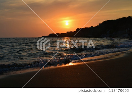 Beautiful sunset on the beach with the sea. Greece - island of Corfu (Kerkyra). Concept for travel, holidays and summer vacations. Beautiful sunset on the beach with the sea. Greece - island of Corfu (Kerkyra). Concept for travel, holidays and summer vacations. 118470693