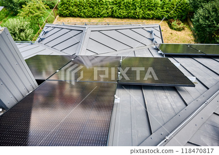 House with solar panels on rooftop for generating electricity through photovoltaic effect. Home with solar power system on roof. Concept of alternative energy, autonomy, power sustainable resources. House with solar panels on rooftop for generating electricity through photovoltaic effect. Home with solar power system on roof. Concept of alternative energy, autonomy, power sustainable resources. 118470817