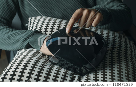 a man is using a hand massager indoors a man is using a hand massager indoors 118471559