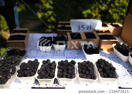 Close up of freshly picked baskets of blackberries on a table for sale at Farmer's Market. Close up of freshly picked baskets of blackberries on a table for sale at Farmer's Market. 118471615
