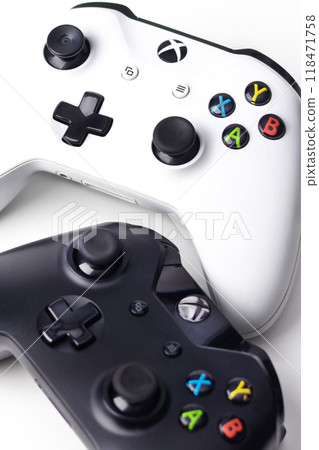 Xbox One S Black and White Controllers on white background vertical photo close up banner Xbox One S Black and White Controllers on white background vertical photo close up banner 118471758
