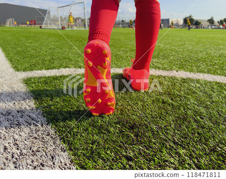 Close up. Soccer player wearing red cleat with small spikes for grip 118471811