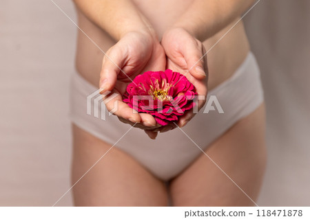A flower blooms on a woman's hips as a symbol of ovulation A flower blooms on a woman's hips as a symbol of ovulation 118471878