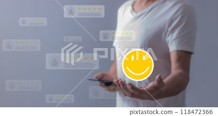 Experience; Review, Young Man using smartphone mobile hand holding emoji to review and give 5 stars Experience; Review, Young Man using smartphone mobile hand holding emoji to review and give 5 stars 118472366