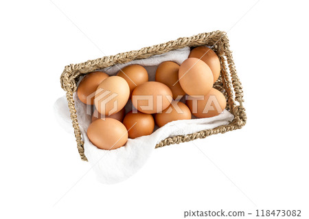 Rustic Basket filled with Brown Eggs on White Cloth, Isolated Rustic Basket filled with Brown Eggs on White Cloth, Isolated 118473082