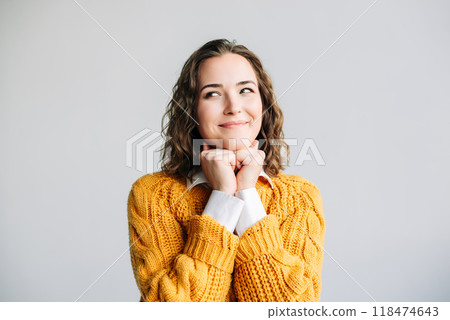 Smiling Woman Dreaming and Thinking. Young woman with a dreamy smile, hands resting on her chin 118474643