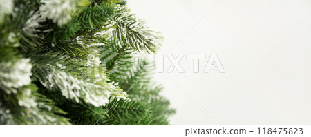 Banner of Christmas snowy with evergreen fir branches on white background. Xmas greeting card. Holiday time. Copy space. Close up. Banner of Christmas snowy with evergreen fir branches on white background. Xmas greeting card. Holiday time. Copy space. Close up. 118475823