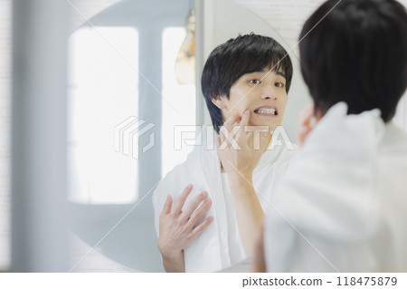 Man doing skin care in the bathroom 118475879