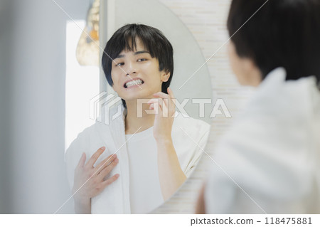 Man doing skin care in the bathroom 118475881