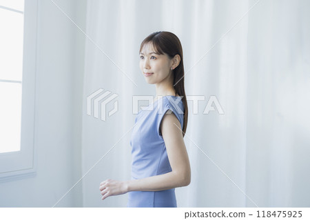 Woman in light blue dress Woman in light blue dress 118475925