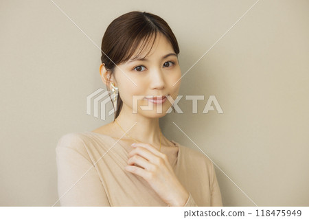 Woman in a beige dress Woman in a beige dress 118475949