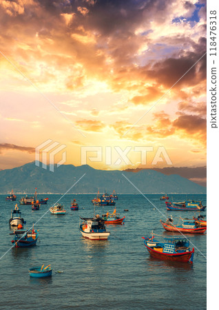 Vietnamese traditional fishing boats in sea at marina at sunset in summer 118476318