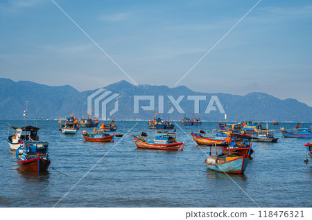 Vietnamese traditional boats at sea at port in a fishing village near Nha Trang in Vietnam during the summer day Vietnamese traditional boats at sea at port in a fishing village near Nha Trang in Vietnam during the summer day 118476321