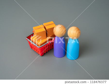 Shoppers and a shopping cart with boxes of goods. Customers buyers and their preferences. Demand in the market. Products and services. Marketing and advertising. Consumption and solvency. 118476377