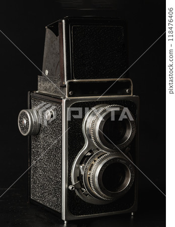 Vintage twin lens reflex photo camera or Old two lens medium format film camera on black background. Vintage twin lens reflex photo camera or Old two lens medium format film camera on black background. 118476406