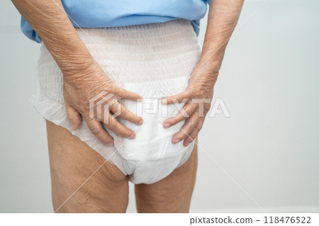 Asian elderly woman wearing diaper for loss of bladder urinary incontinence control. 118476522