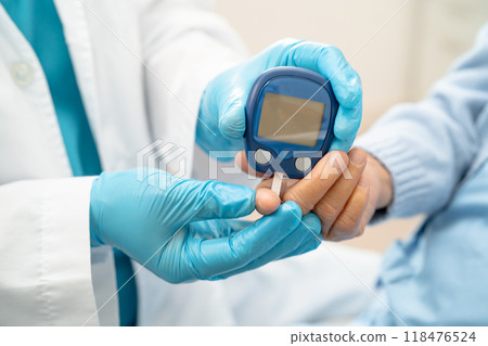 Doctor use digital glucose monitor measure and test stripe for check diabetes from finger blood sugar level. Doctor use digital glucose monitor measure and test stripe for check diabetes from finger blood sugar level. 118476524