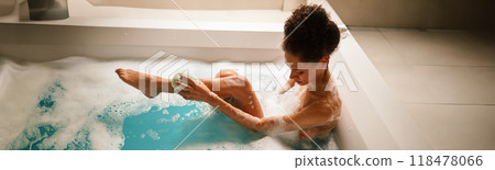 Woman happily bathing in leisure with water art and fun gestures in the bathtub Woman happily bathing in leisure with water art and fun gestures in the bathtub 118478066