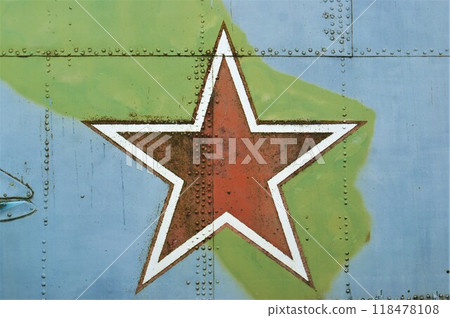 A star on the fuselage of an old military helicopter. The symbol of the Soviet Union is a red star. 118478108