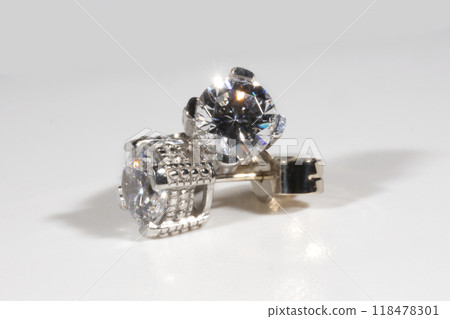 Diamond earrings. Big diamond earrings, large solitaire earrings on white background. Diamond earrings. Big diamond earrings, large solitaire earrings on white background. 118478301